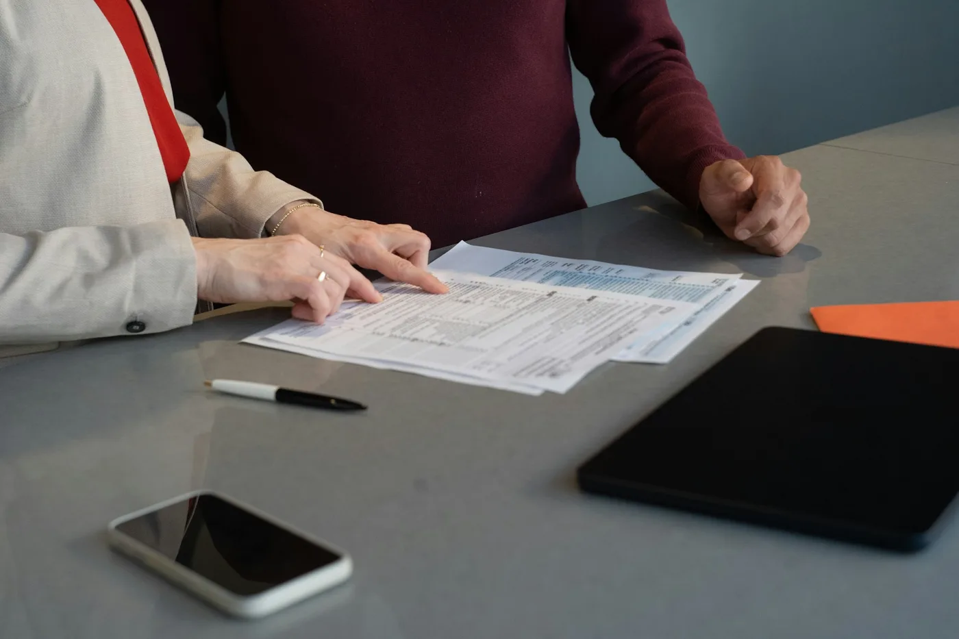 Two people reviewing documents together at a table